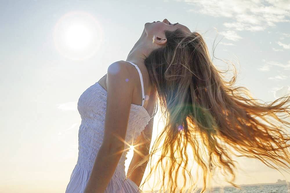 Caucasian woman tossing her hair outdoors