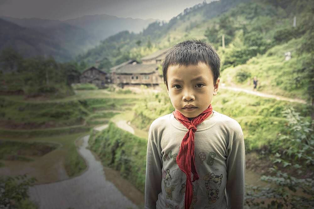 Chinese boy standing in rice paddy fields