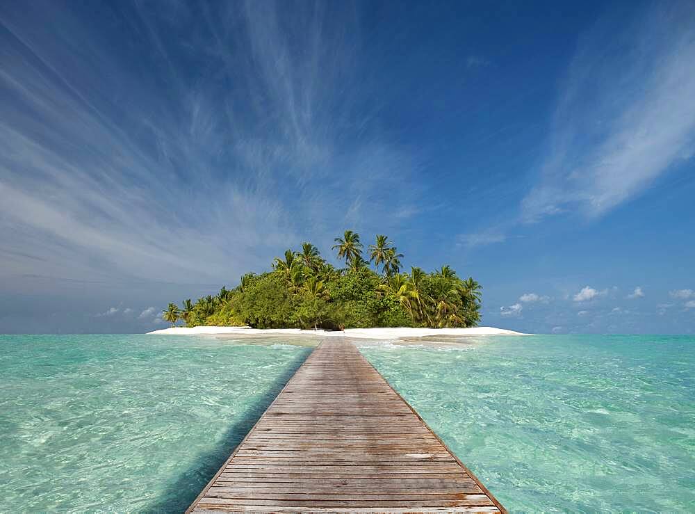 Wooden dock walkway to tropical island