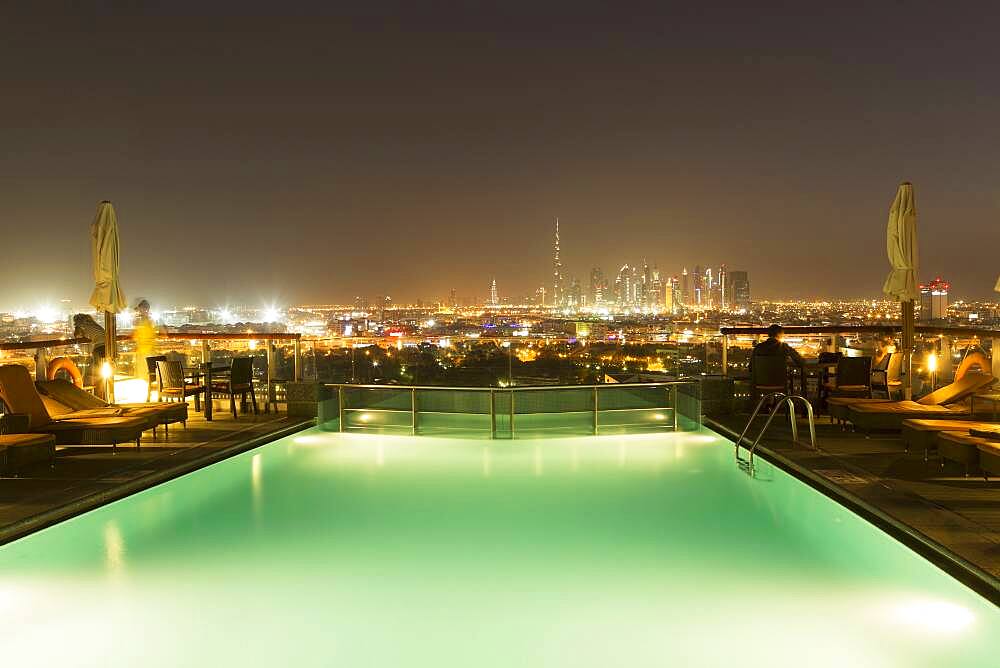 Swimming pool over cityscape at night, Abu Dhabi Emirate, United Arab Emirates