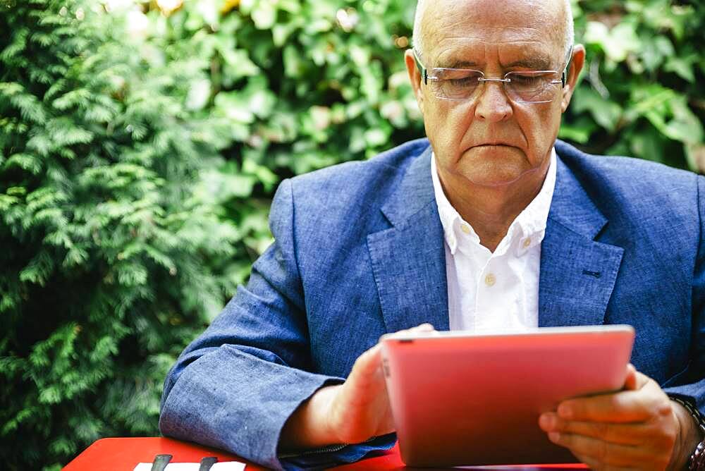 Hispanic businessman using digital tablet