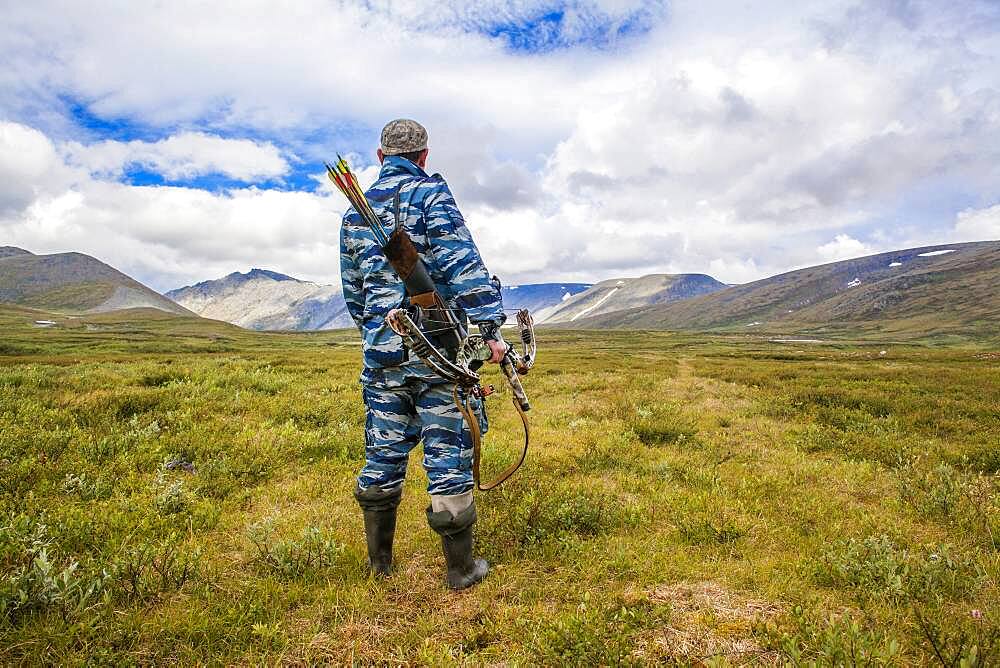 Mari hunter carrying crossbow in remote field