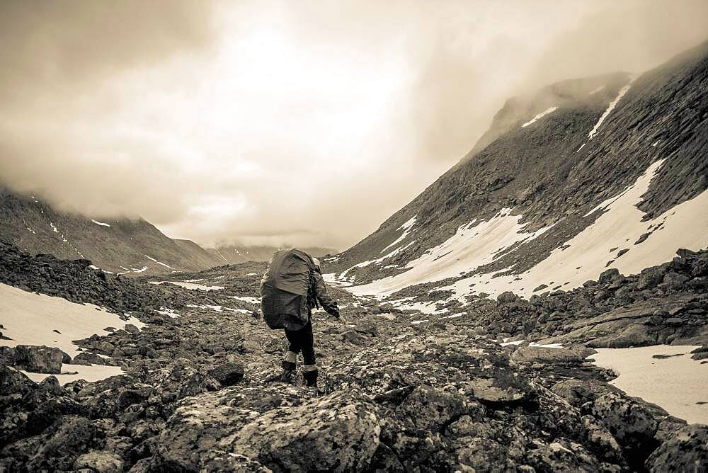 Mari backpacker walking in mountain valley