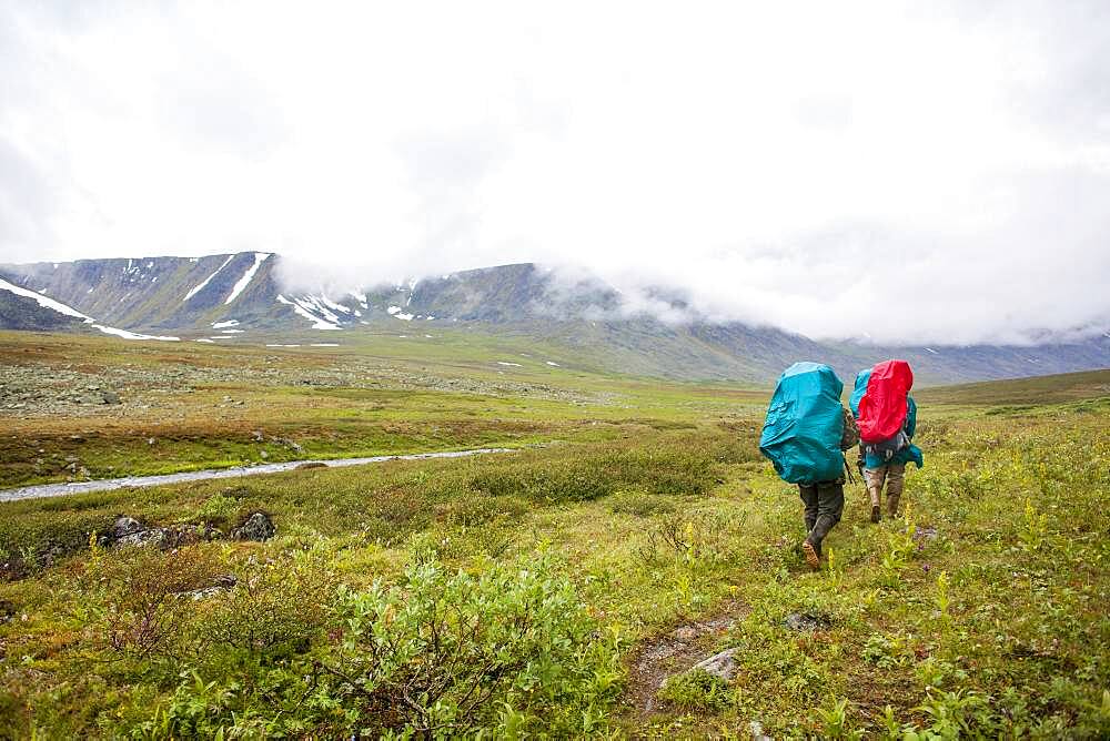 Backpackers walking on rural path