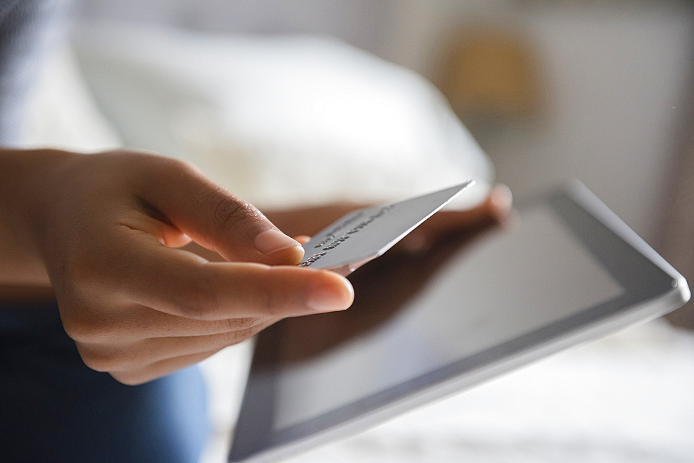 Hands of African American woman online shopping with digital tablet