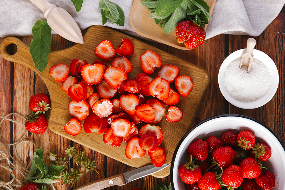 Close up of sliced strawberries on cutting board