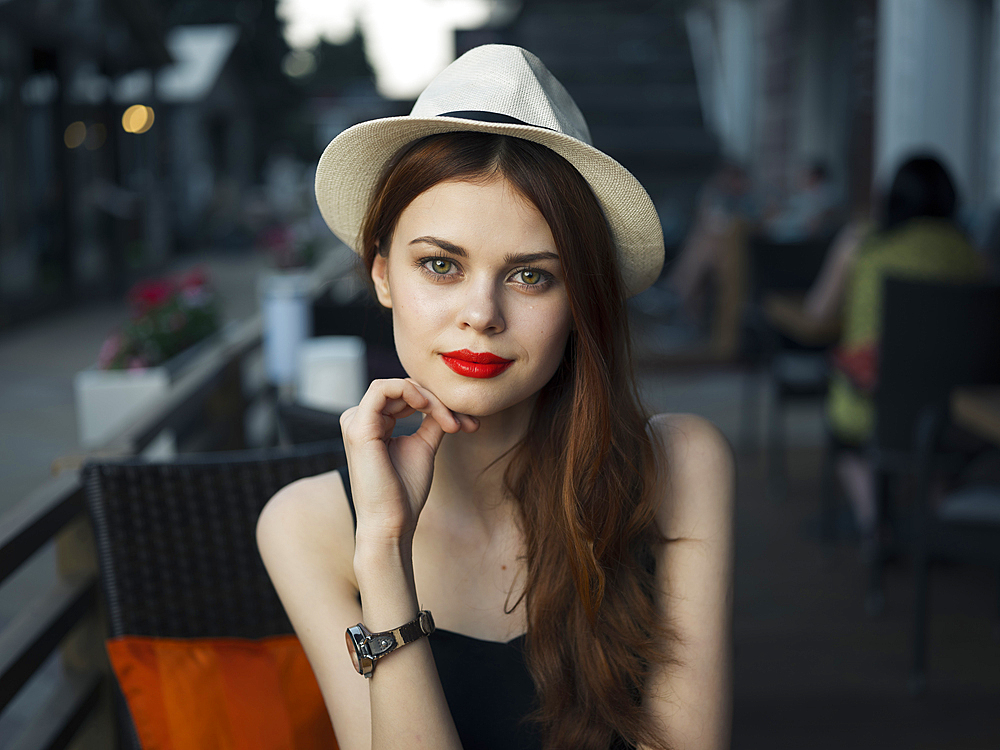 Confident Caucasian woman at sidewalk cafe