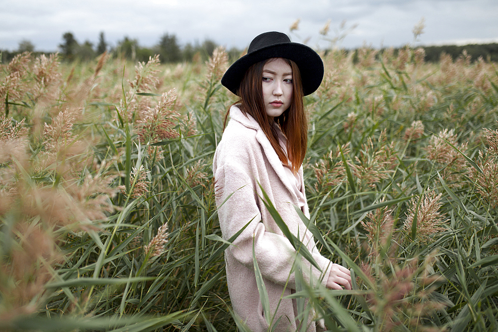 Asian woman standing in field