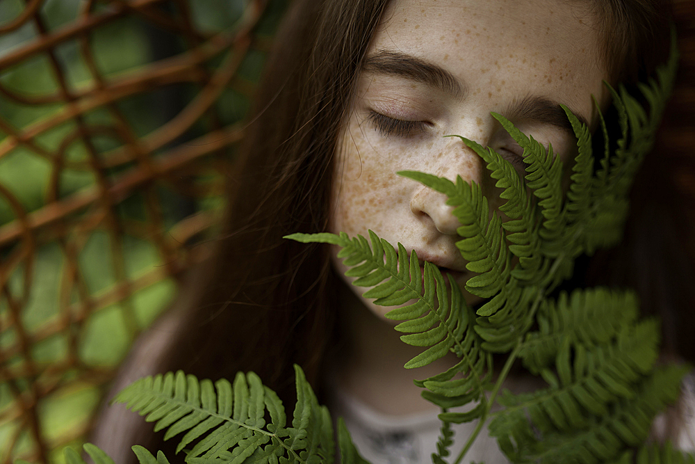 Caucasian girl smelling leaves