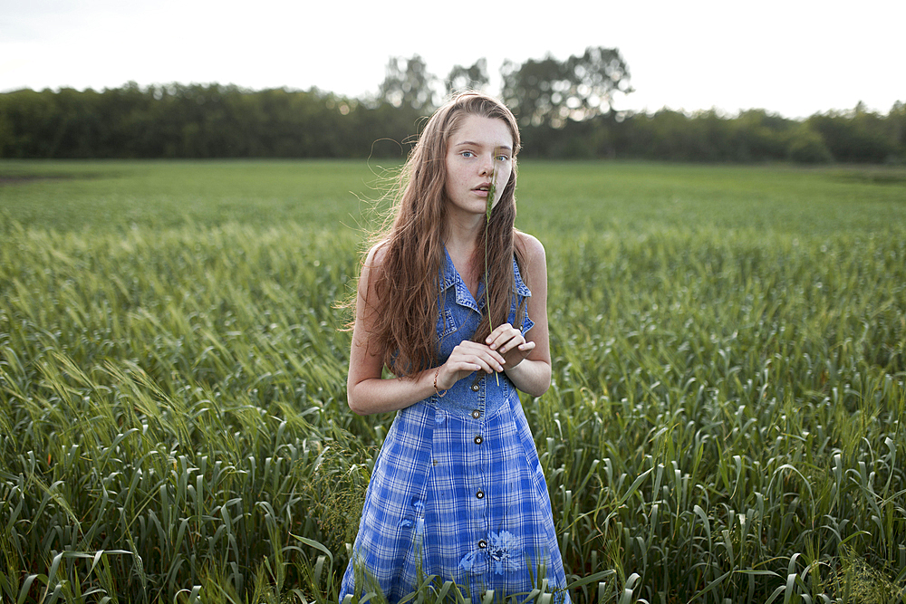 Portrait of Caucasian woman standing in field on farm