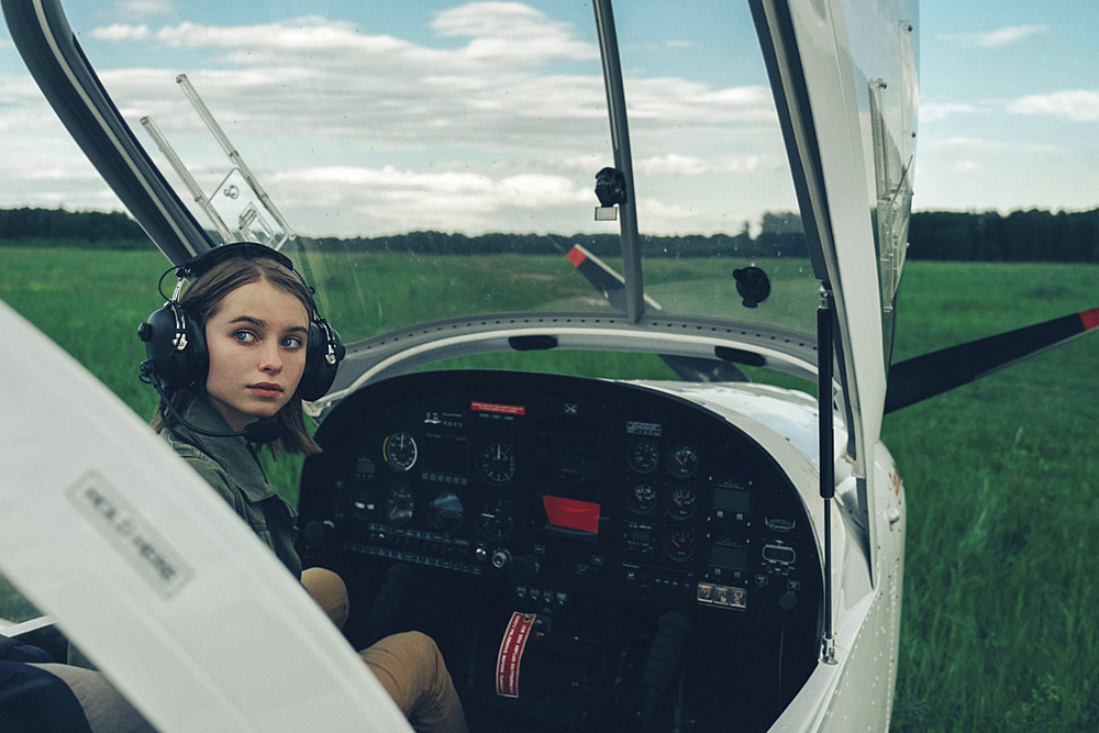 Caucasian woman sitting in airplane cockpit