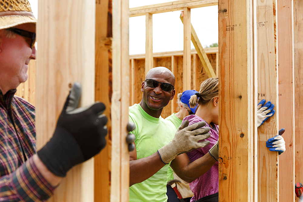 Volunteers holding wall at construction site