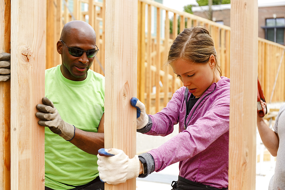 Volunteers holding wall at construction site