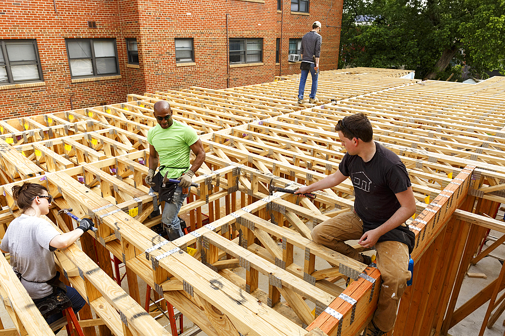 Volunteers hammering at construction site