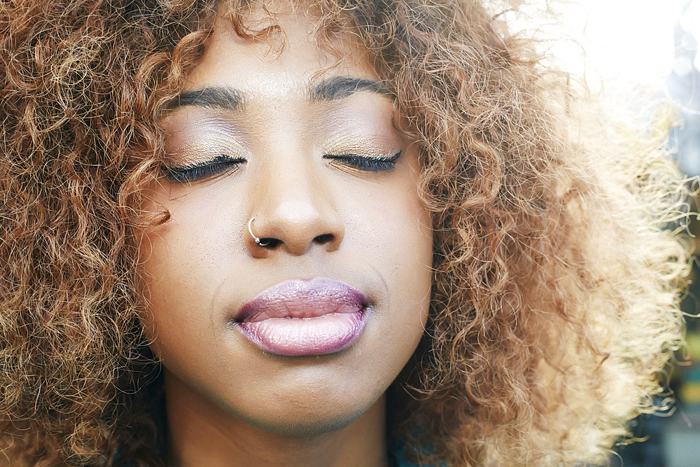 Close up of black woman with eyes closed