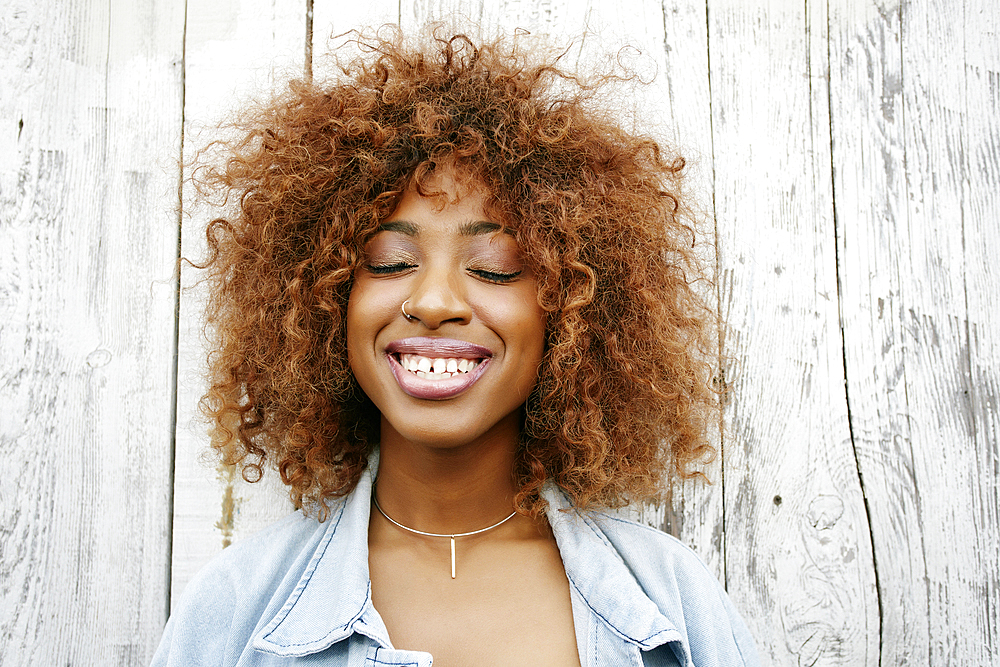 Close up of smiling black woman with eyes closed