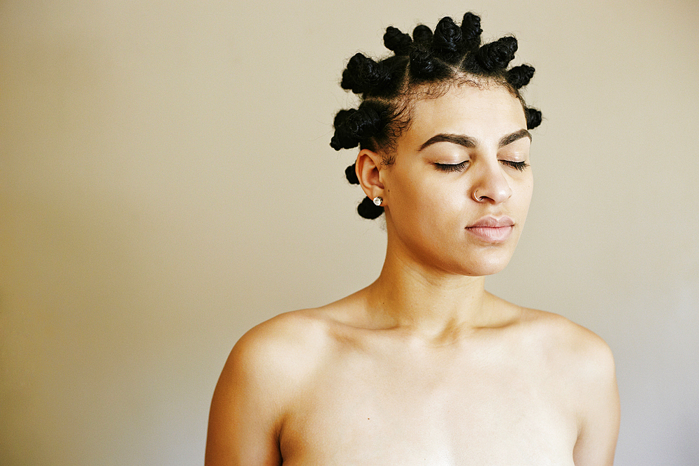 Portrait of Mixed Race woman with eyes closed