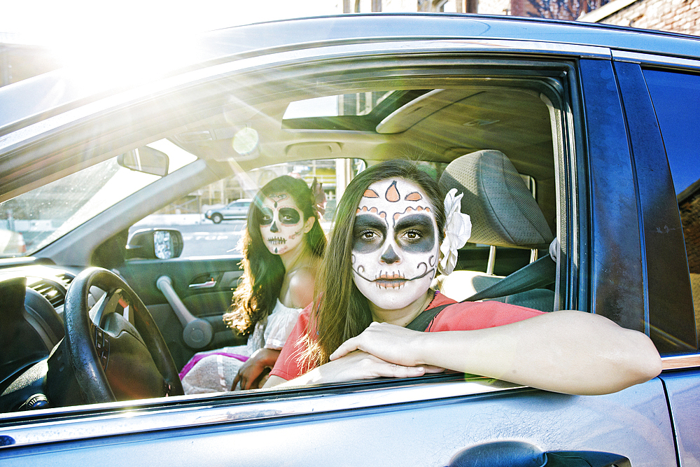 Women in car wearing skull face paint