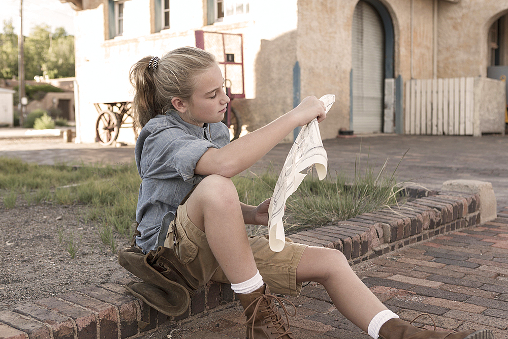 Caucasian girl reading map