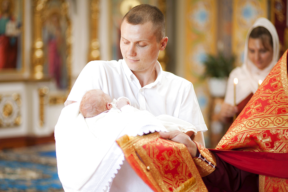 Father holding baby son in church