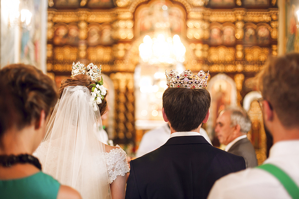 Couple wearing crowns in church