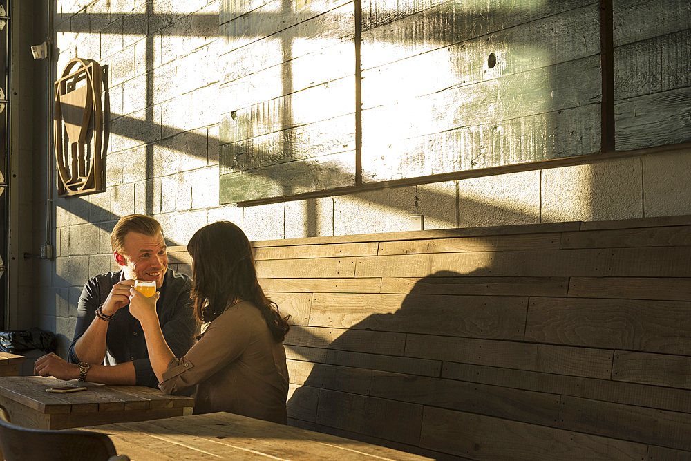 Caucasian couple talking in brew pub