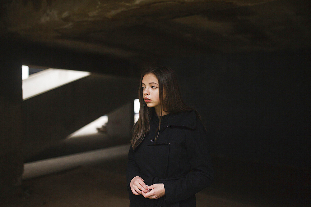 Pensive Caucasian woman wearing black coat