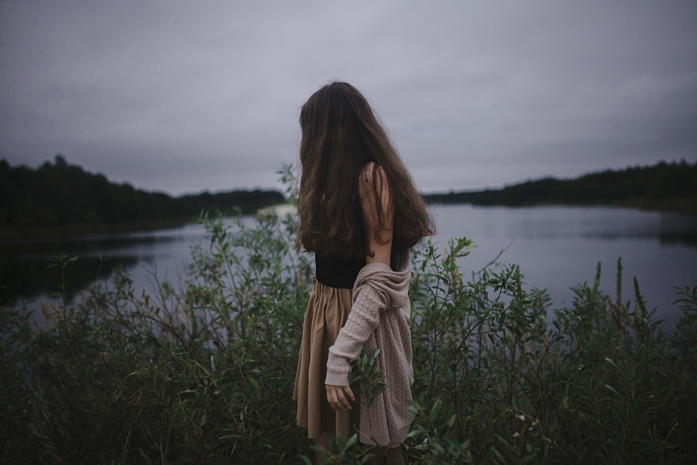 Caucasian woman standing near river