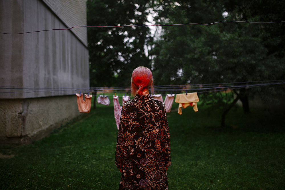 Caucasian woman staring at clothesline