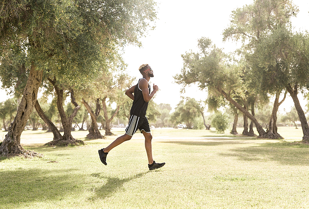 Black man running in park