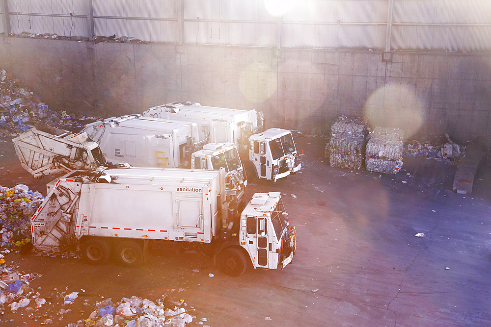 Garbage trucks unloading trash