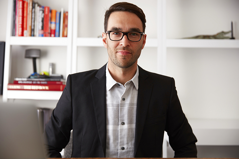 Portrait of smiling Caucasian businessman in office