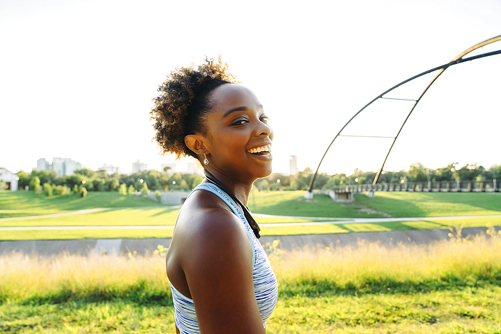 Portrait of smiling mixed race woman in park