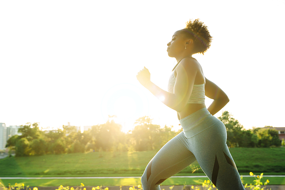 Mixed Race woman running in park