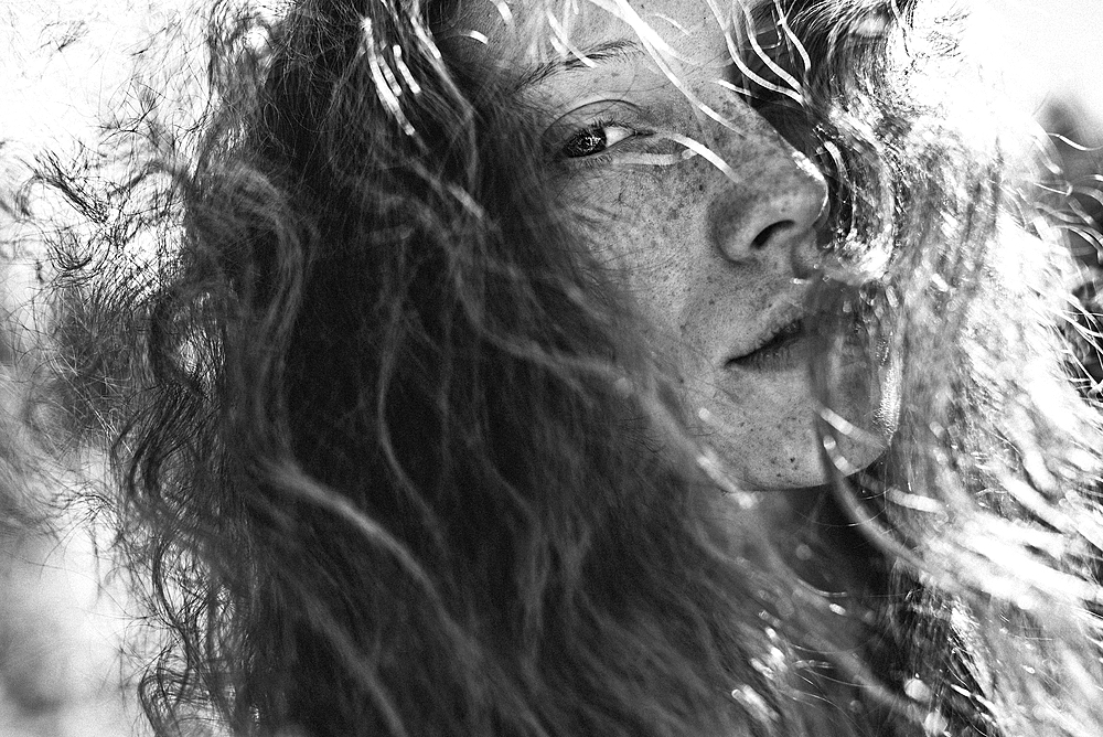 Wind blowing hair of Caucasian woman