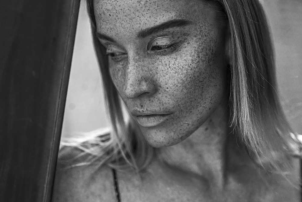 Close up of pensive Caucasian woman with freckles