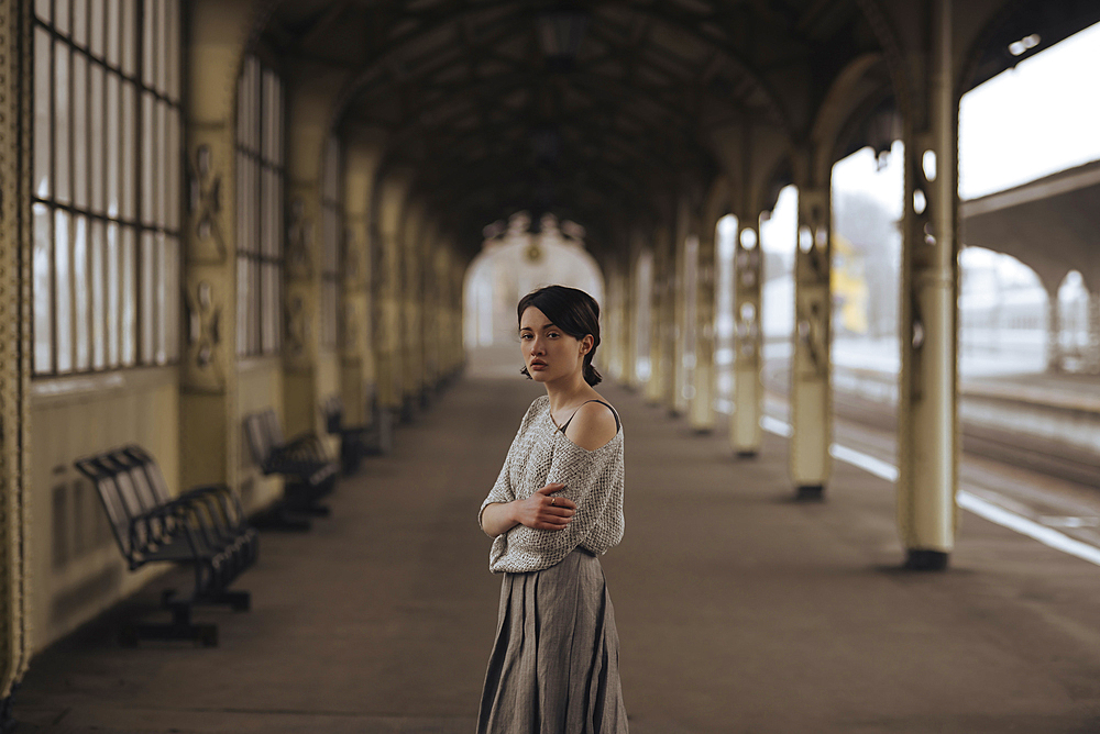 Portrait of serious Caucasian woman at train station