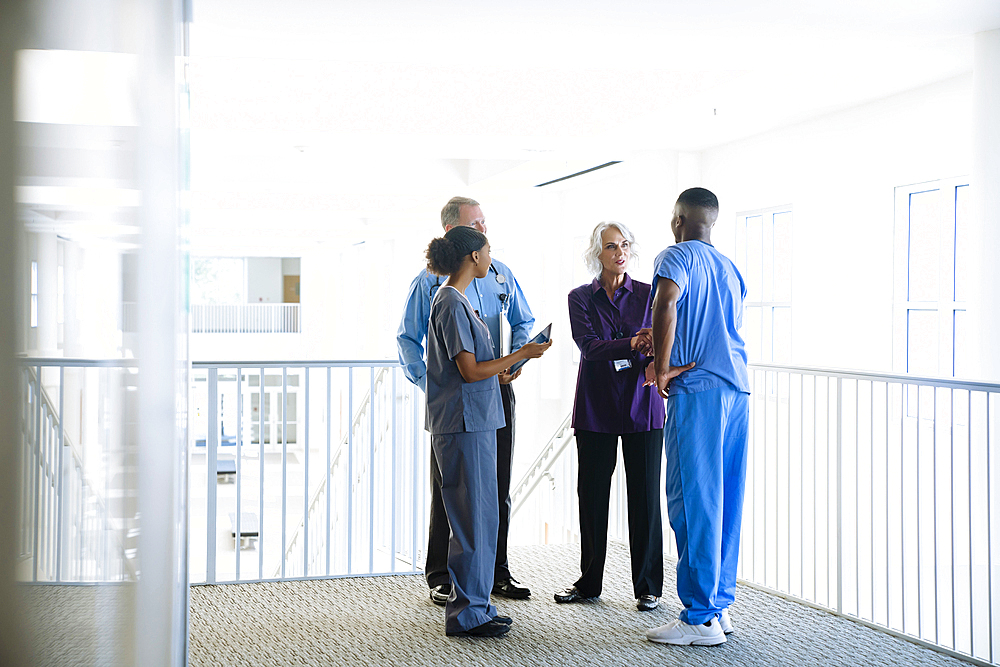 Doctors and nurses talking near staircase