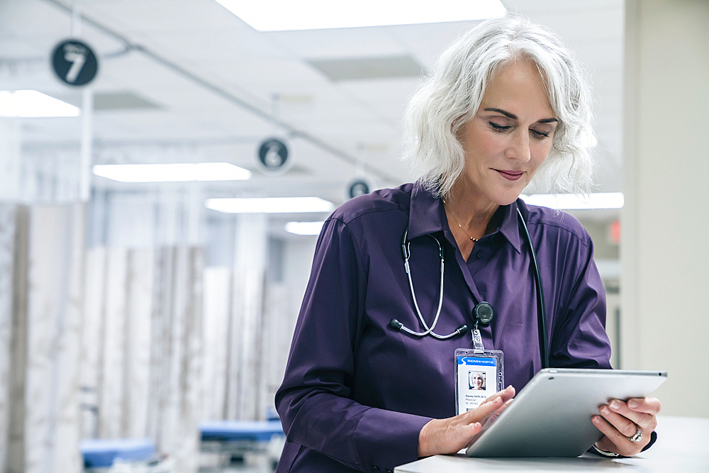 Caucasian doctor using digital tablet in hospital