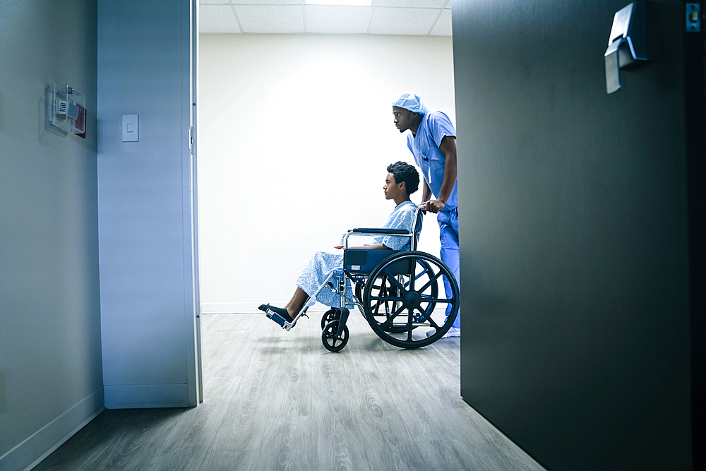 Nurse pushing boy in wheelchair