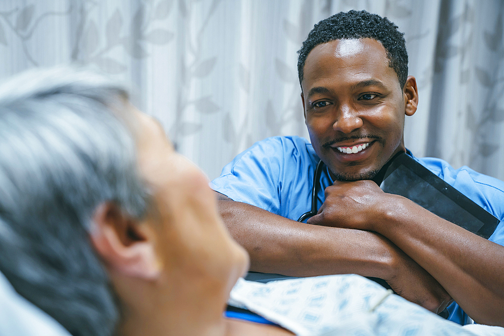 Nurse talking to patient in hospital bed