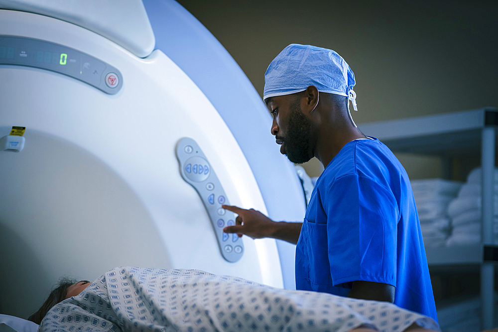 Technician talking to patient at scanner