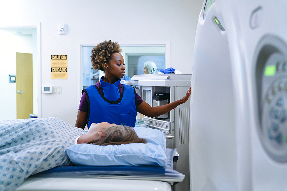 Technician preparing scanner for patient