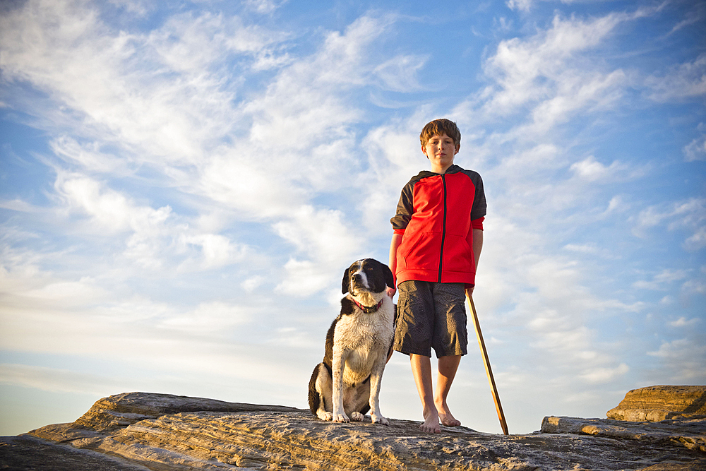 Caucasian boy hiking with dog