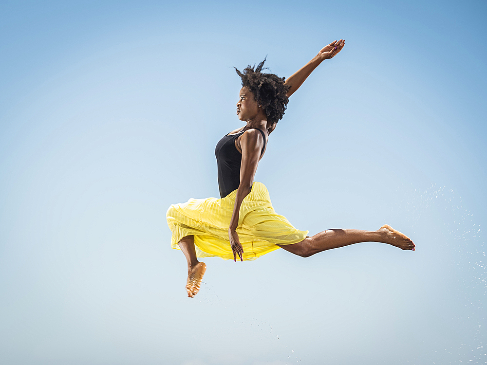 Black woman dancing and jumping