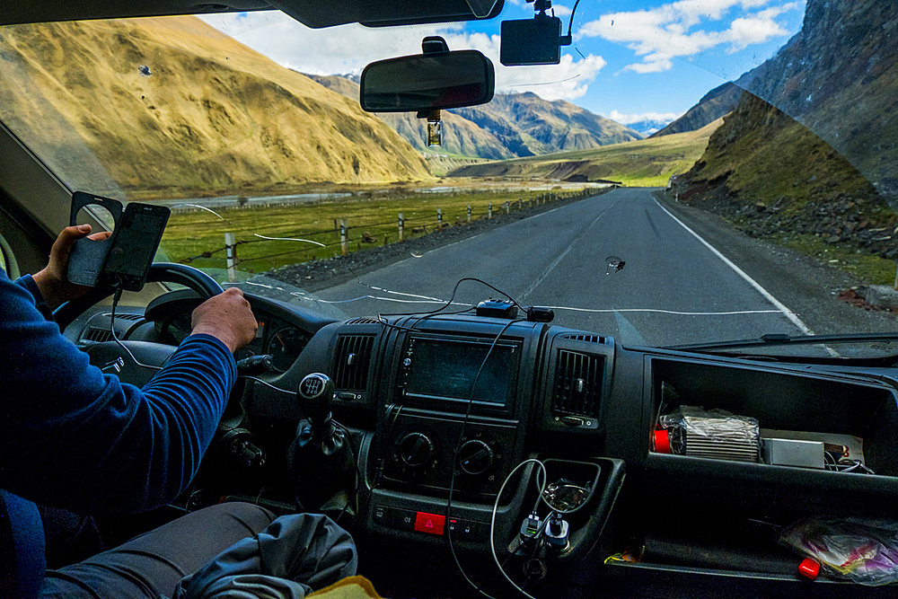 Caucasian man driving car while using cell phone