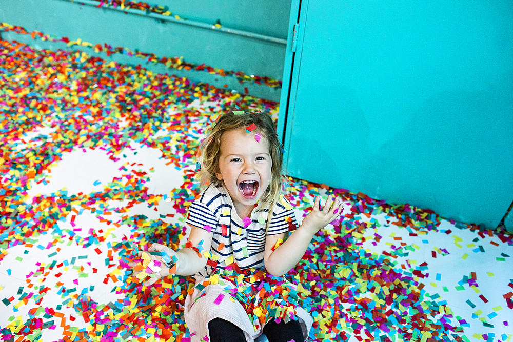 Colorful confetti falling on Caucasian girl