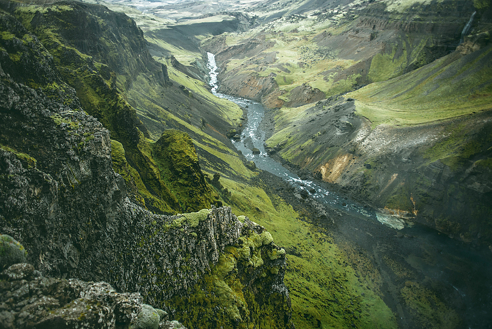 Scenic view of river in green valley