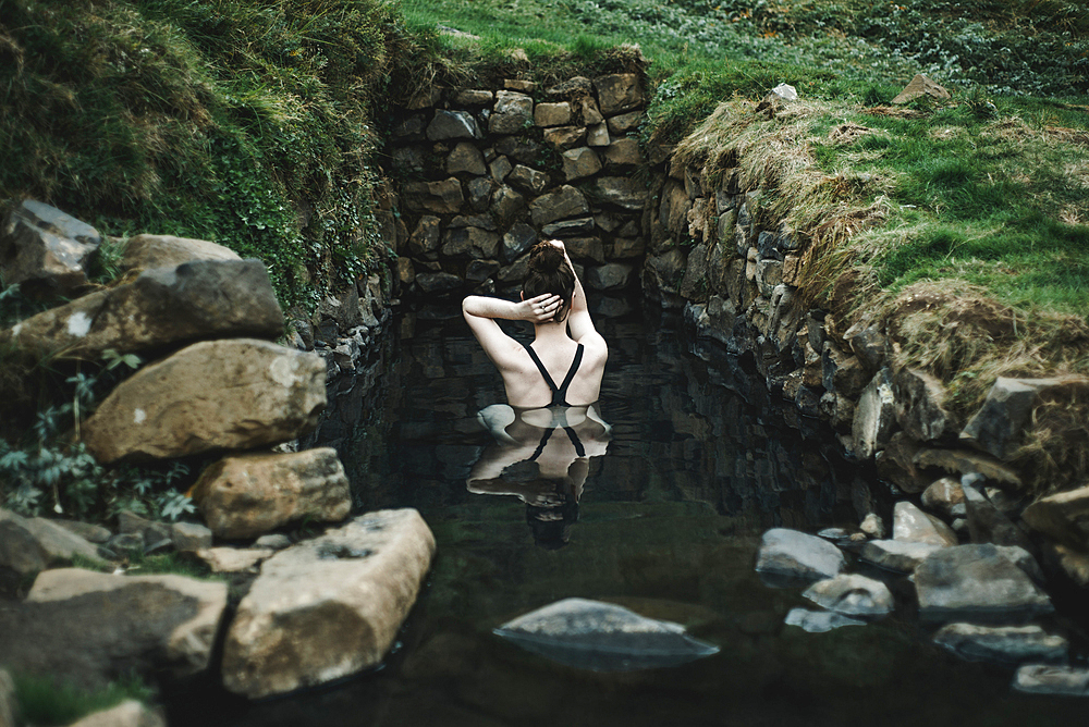 Caucasian woman swimming in pond