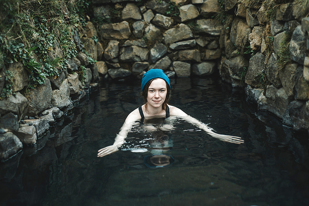 Portrait of smiling Caucasian woman wearing stocking-cap swimming